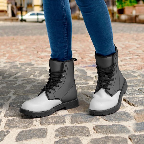 A model wears a pair of grey and black waterproof leather boots