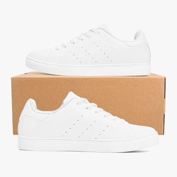 A pair of white low-top sneakers are placed on a shoe box