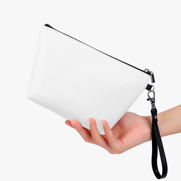 A female hand holds a white makeup bag in one hand