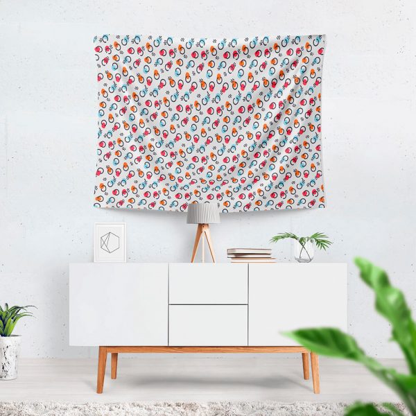 A patterned cute tapestry hangs on the wall, with a table beneath it.