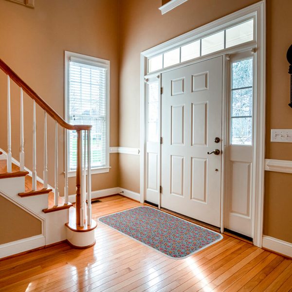 a patterned doormat is placed in front of the interior door