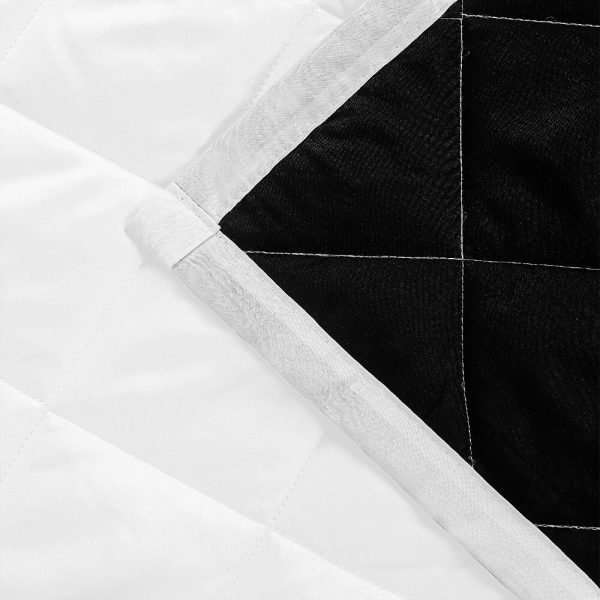 The corner of the pure white quilt cover is folded up to reveal the black inner lining