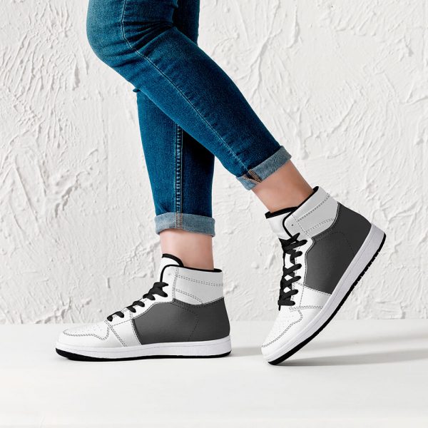 A female model wears a pair of gray-black high-top sneakers