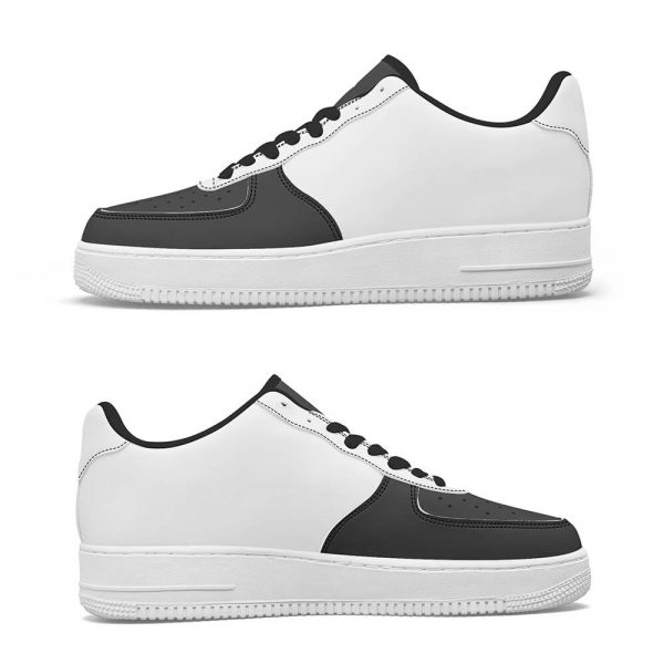 Side view of a pair of black low-top sneakers arranged one on top of the other