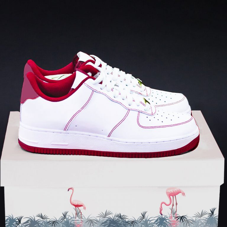 A pair of custom shoes placed on a branded custom shoe box