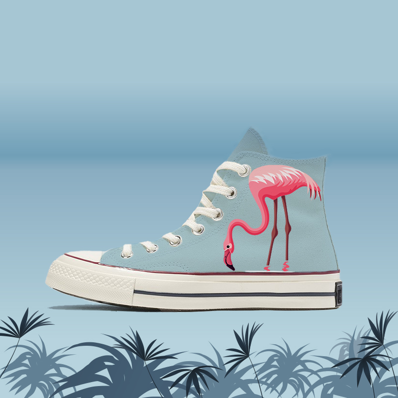 A pair of canvas shoes with flamingos printed on them