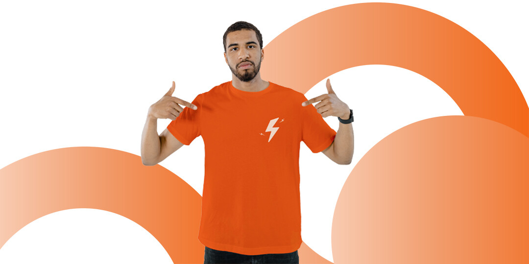 A model wearing an orange print on demand T-shirt from an Etsy shop connected to JetPrint
