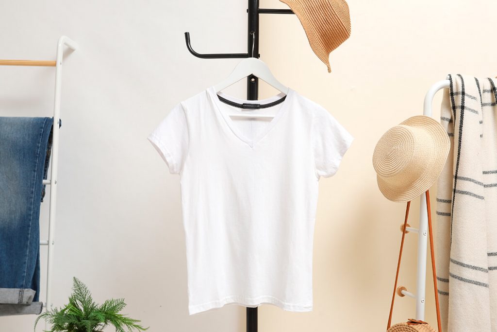 White t-shirts are hung on hangers