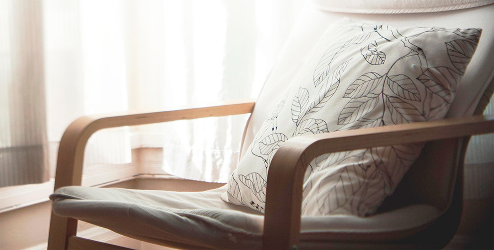 a cushion serves as a backrest for a table and chair