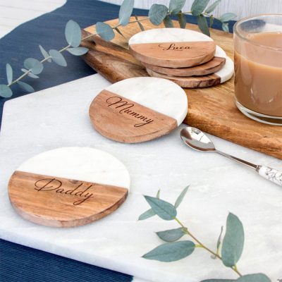 Round coasters made of marble and wood are placed on the table