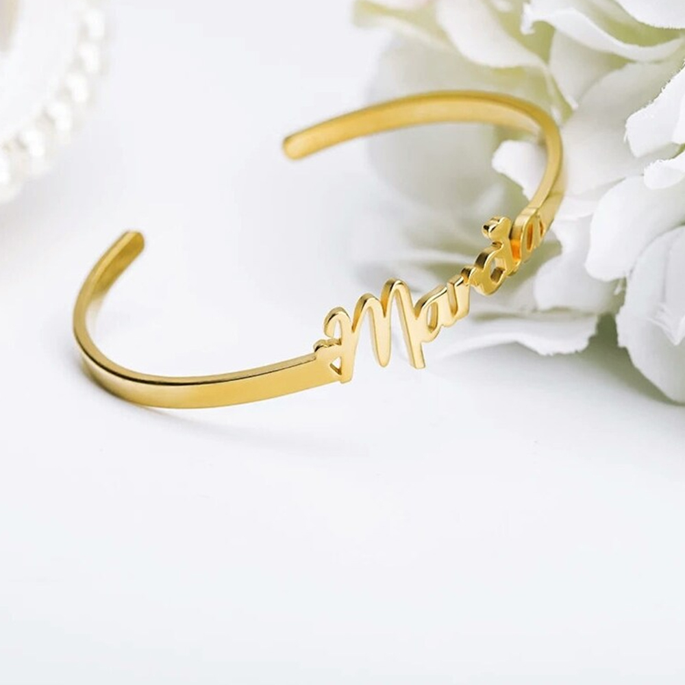 A gold custom name bracelet