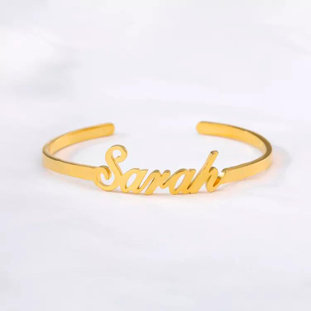 A gold custom name bracelet