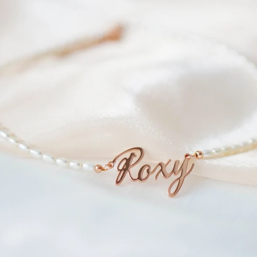 A pearl necklace with engraved name