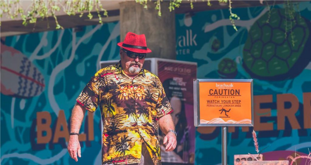 A middle-aged man wearing a Hawaiian shirt