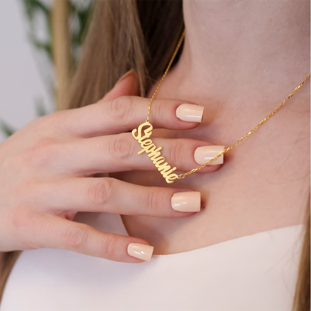 A female model wears a gold customizable necklace