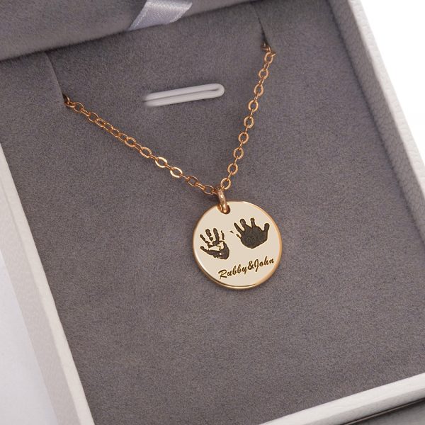 A golden handprint necklace