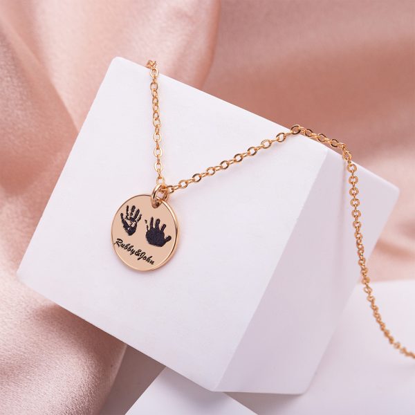 A golden handprint necklace