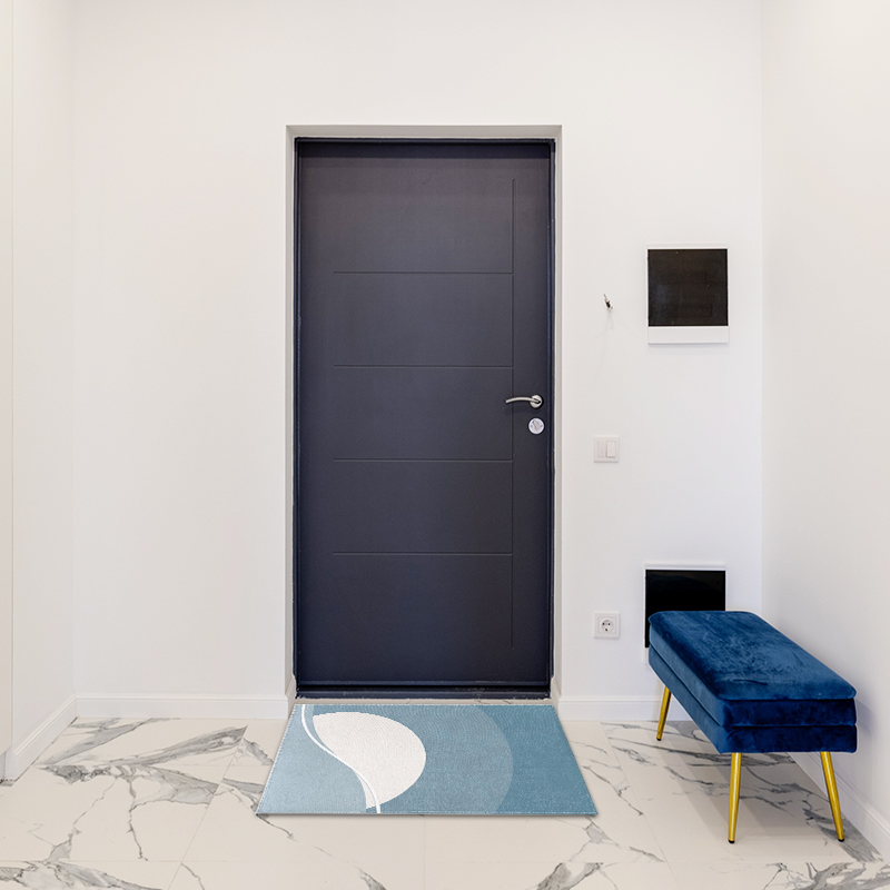 A minimalist home rug is placed in front of the door