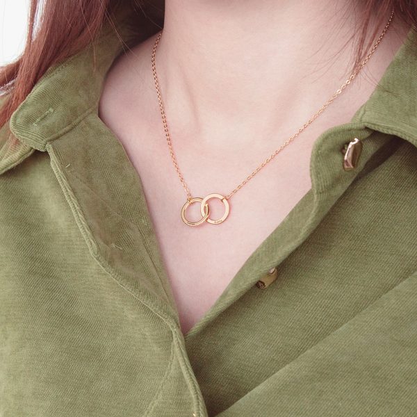 A female model wears a golden interlocking circle necklace