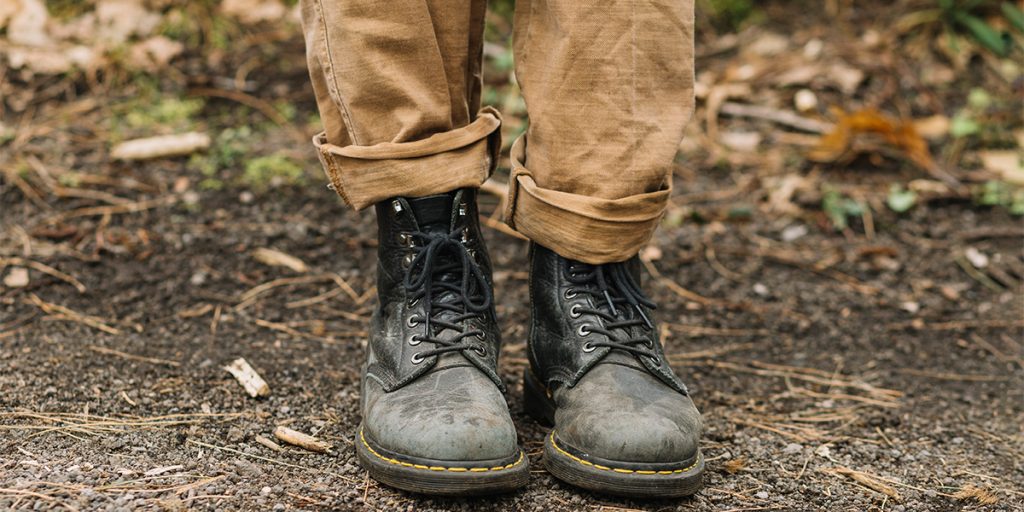 A male model wearing a pair of leather boots