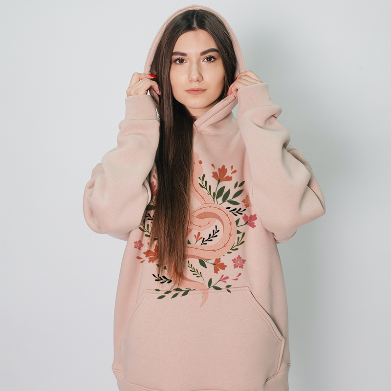 A female model wears a pink hoodie of her own design