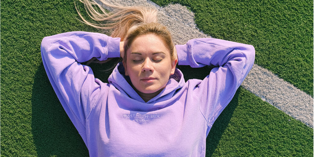 A woman wears a purple hoodie with embroidery