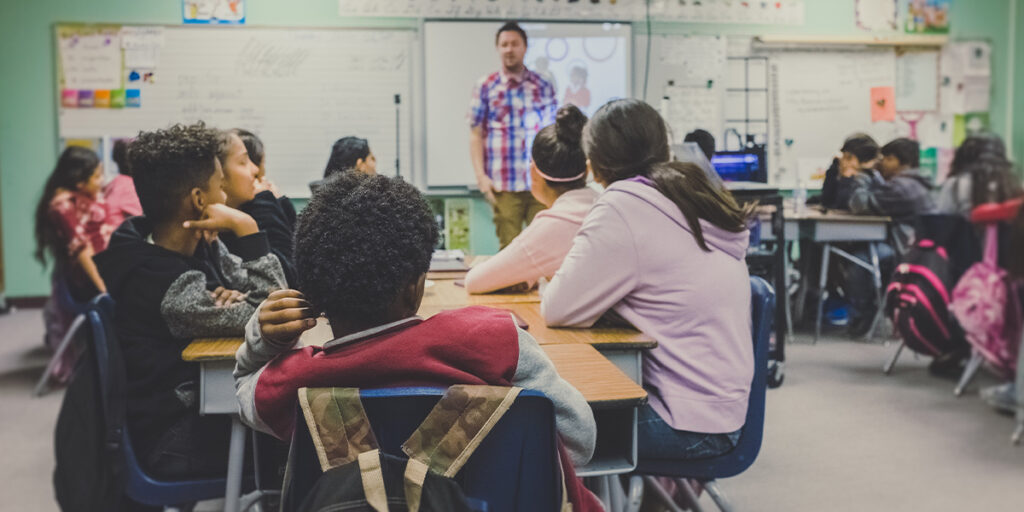 A man is teaching a lesson to his students