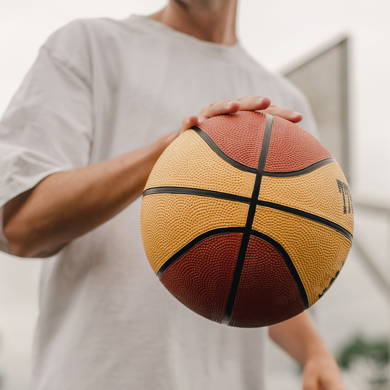 A man in white clothes is playing basketball