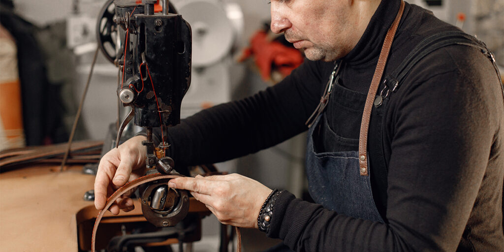 A man is using a sewing machine