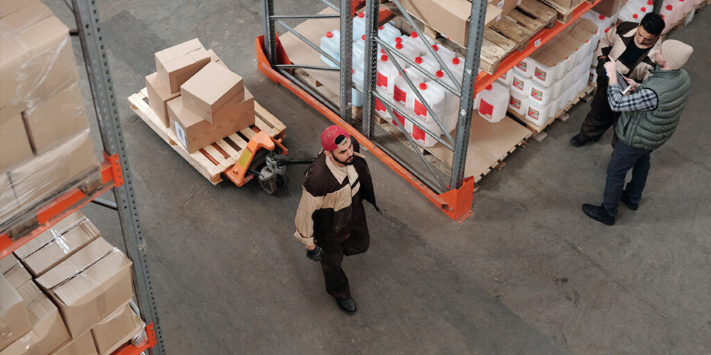 A man is shipping products in bulk in a warehouse