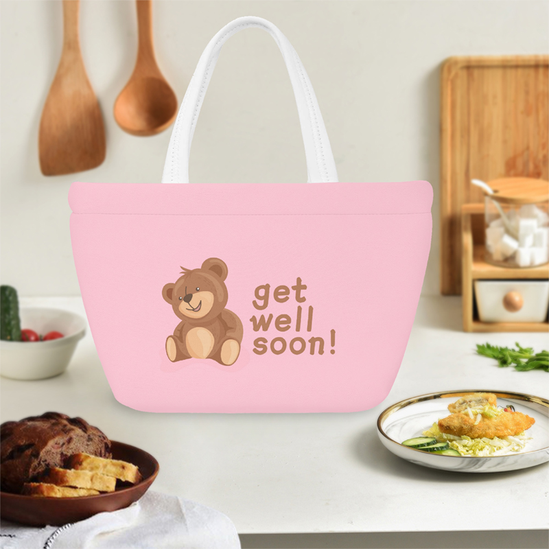 A pink lunch bag with a cute bear