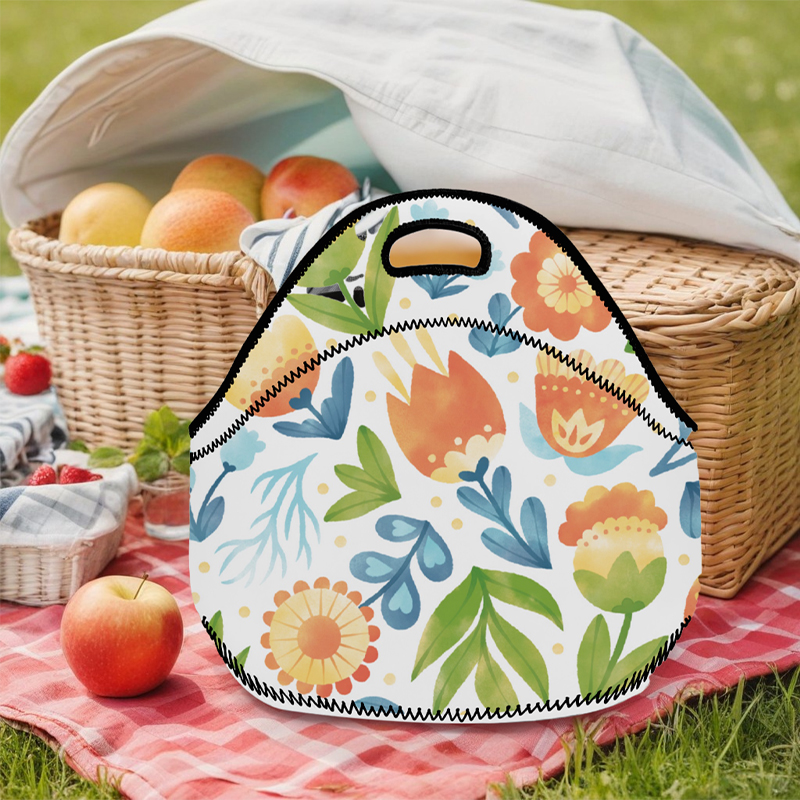 A lunch bag with a floral pattern is placed on the lawn