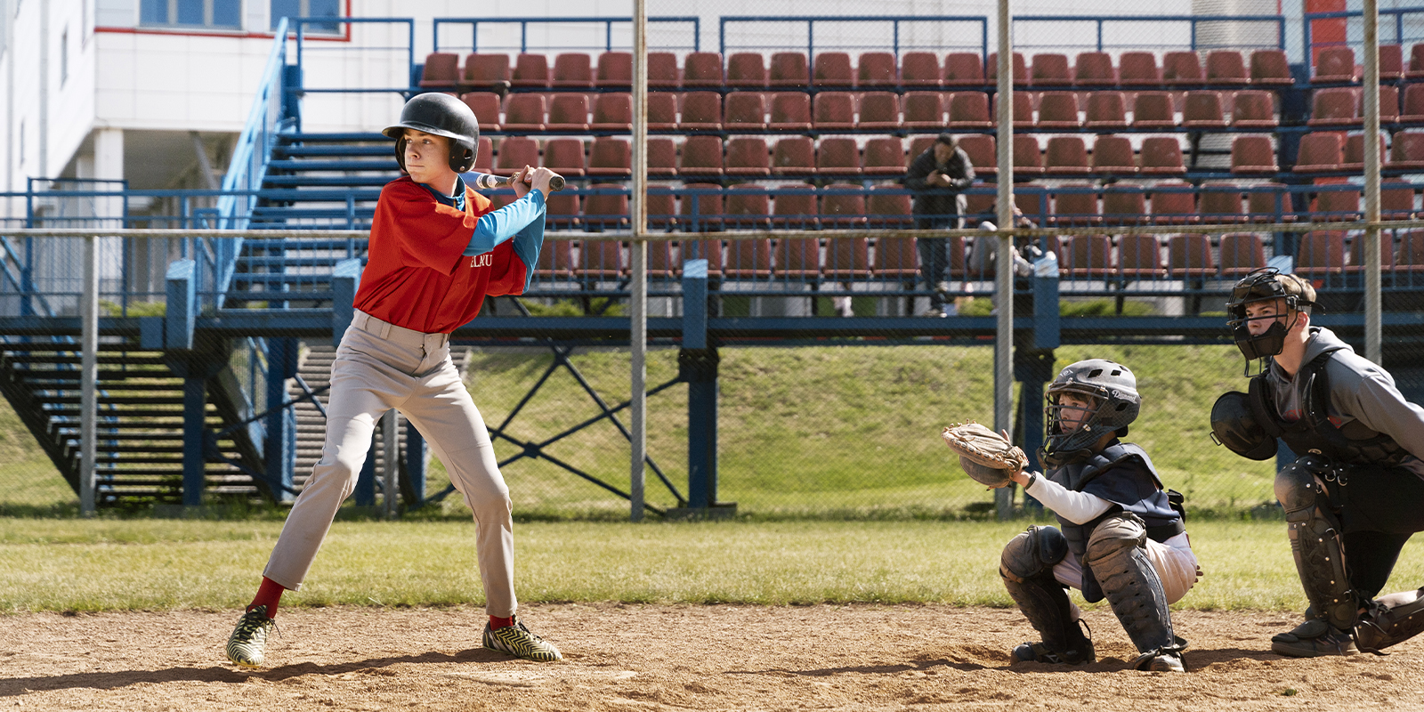 Two teenage baseball players are playing baseball