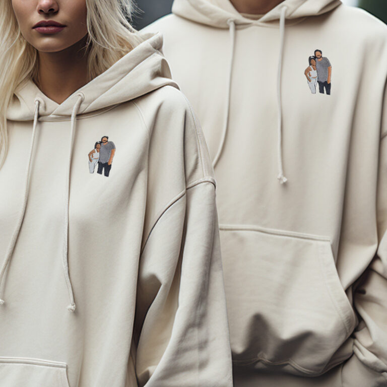 A couple wearing hoodies personalized with embroidered photos