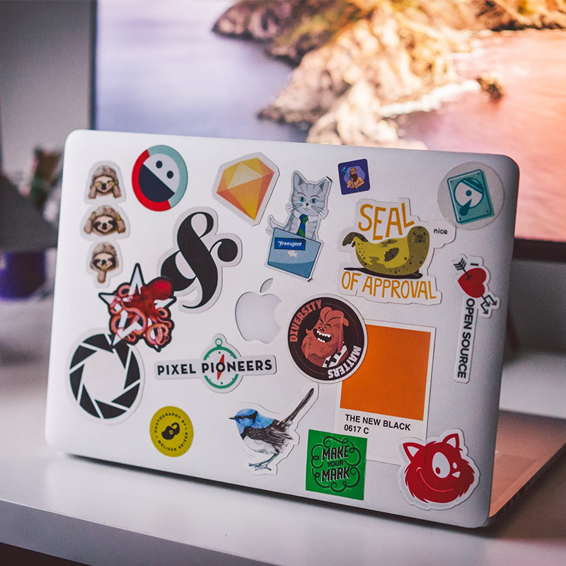 There are many stickers on the back of a macbook