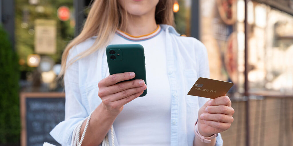 A woman is shopping with a mobile phone