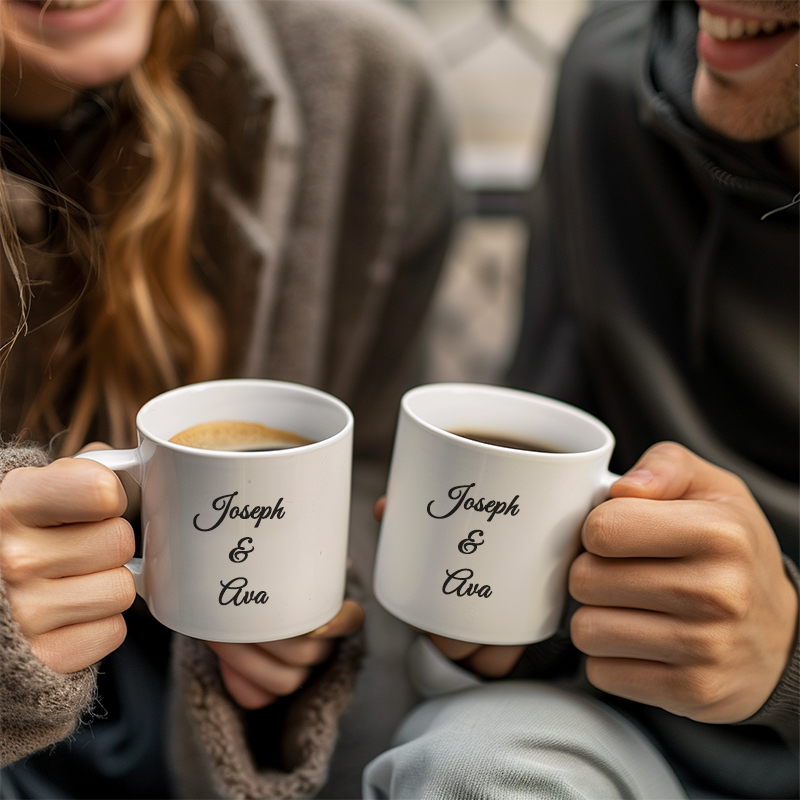 A couple holding white personalized mugs