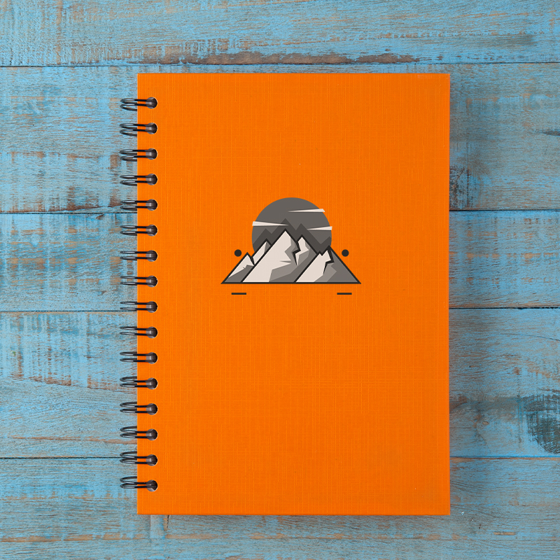 An orange notebook with a brand logo