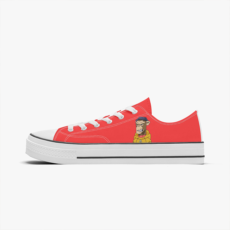 A pair of orange low-top sneakers with a cartoon monkey