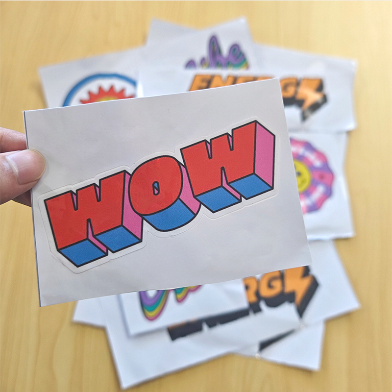 A kiss-cut sticker with the word "WOW"