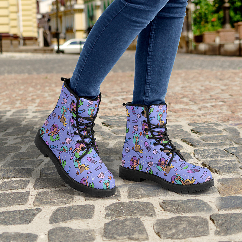 A pair of purple boots with a mermaid pattern