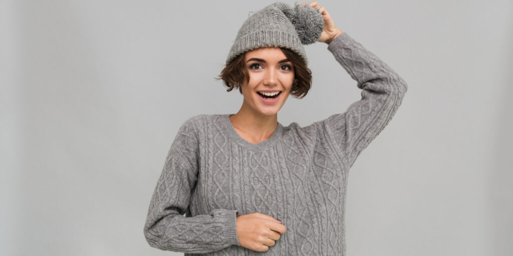 A female model wears a gray sweater