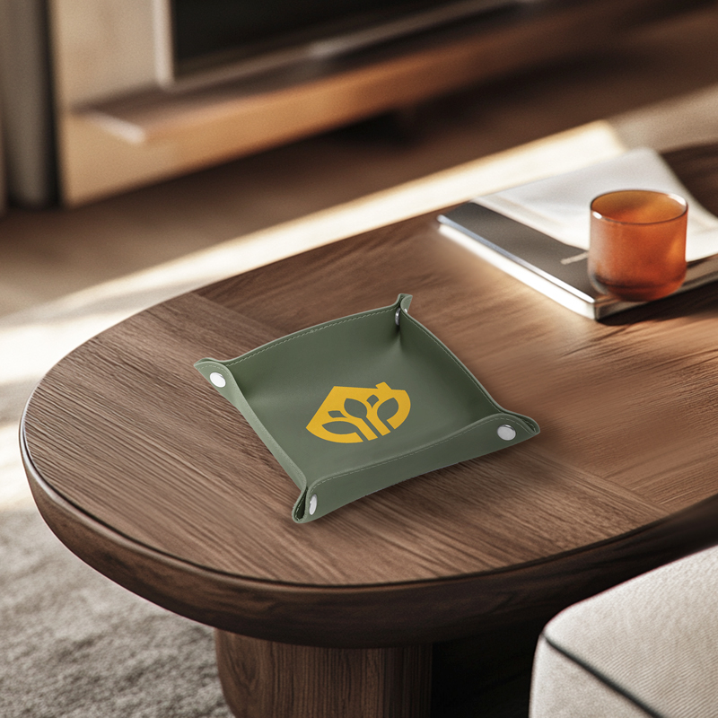 A green leather valet tray is placed on the table as a home decoration