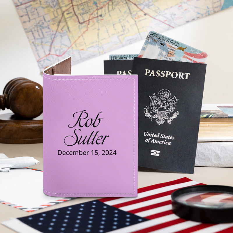 A purple passport cover with name and date is next to the passport