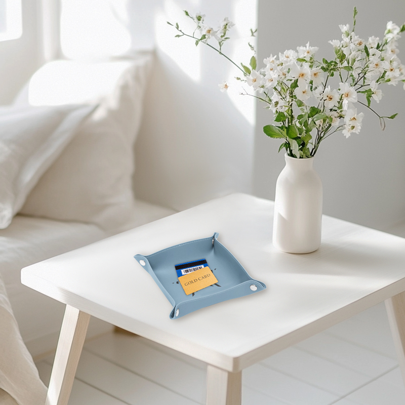 A light blue travel valet with a bank card inside placed on the table