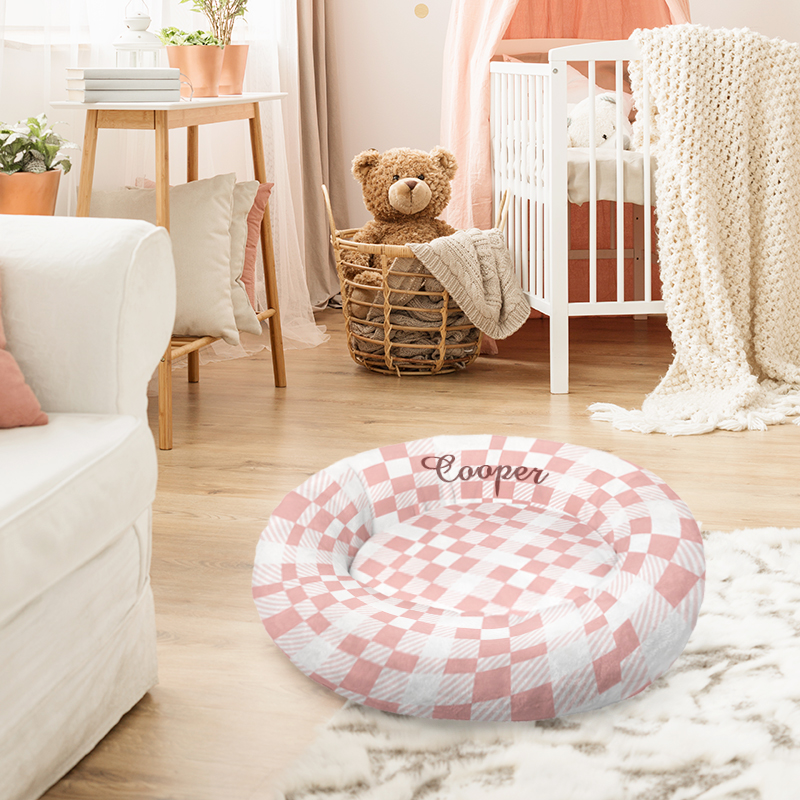 Pink pet bed with checkerboard design