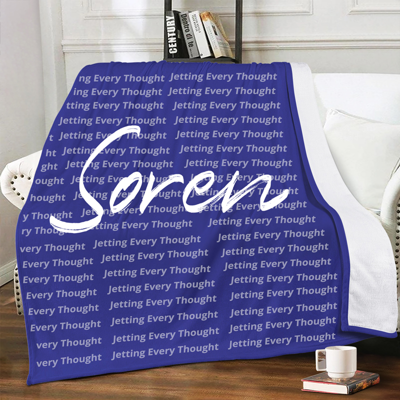 A blue blanket with text printed on it is placed on the sofa