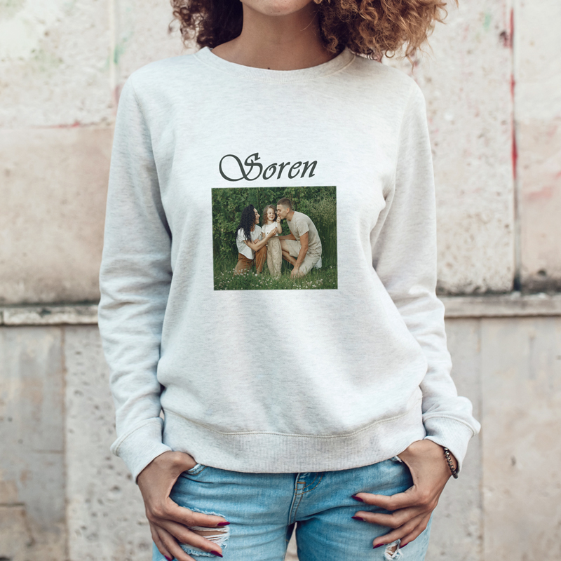 A woman wearing a gray sweatshirt with a photo