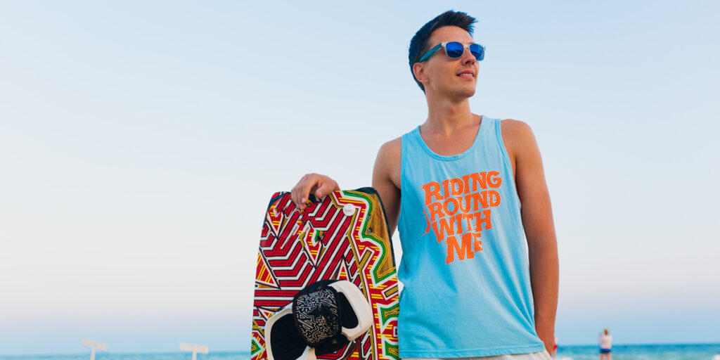 A man wearing this blue tank top on the beach