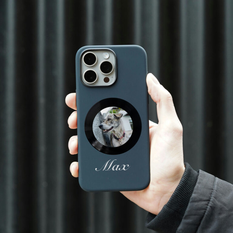 A person holding a personalized phone case with a pet photo printed on it